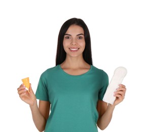 Young woman with menstrual cup and pad on white background