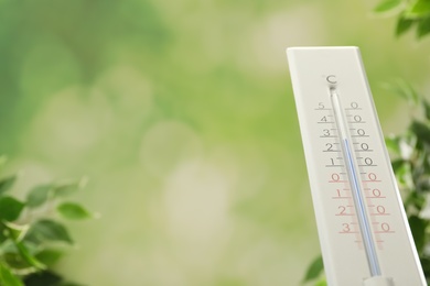 Weather thermometer on blurred background, closeup. Space for text