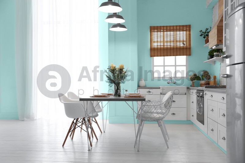 Image of Stylish kitchen interior design inspired by color of the year 2020 (bleached coral)