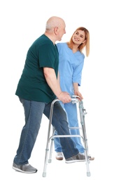 Caretaker helping elderly man with walking frame on white background