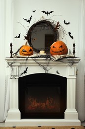 Different Halloween decor on mantelpiece indoors. Festive interior