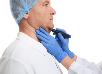 Photo of Surgeon with marker preparing man for operation against white background. Double chin removal