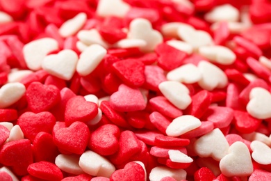 Sweet candy hearts as background, closeup view