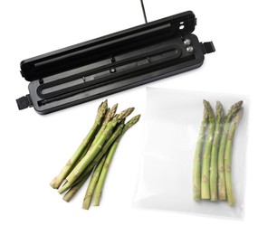 Sealer for vacuum packing and plastic bag of asparagus on white background, top view