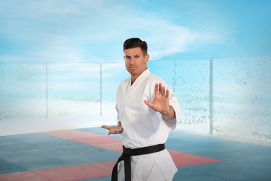 Professional coach showing karate moves at gym