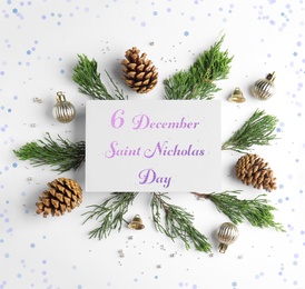6 December Saint Nicholas Day. Composition with Christmas decor and card on white background, flat lay 