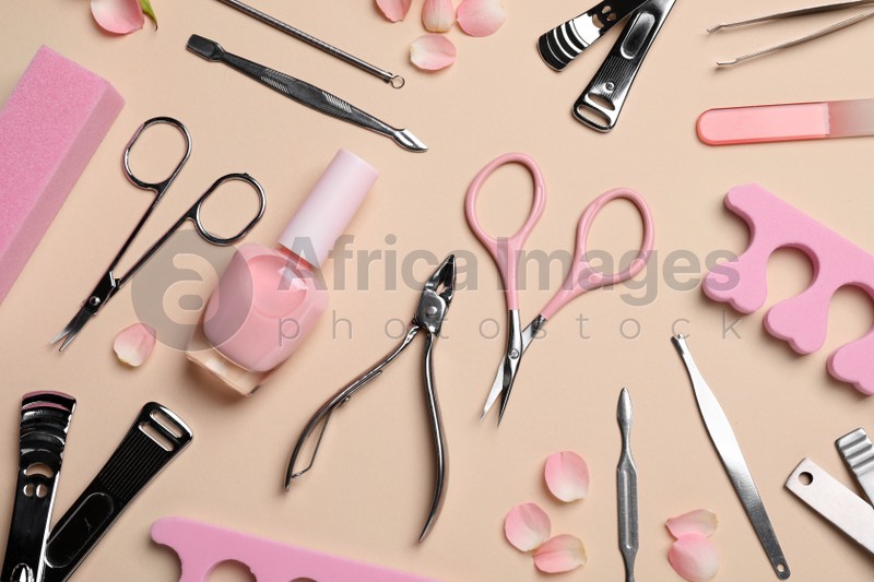 Composition with manicure and pedicure tools on beige background, flat lay