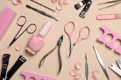 Composition with manicure and pedicure tools on beige background, flat lay