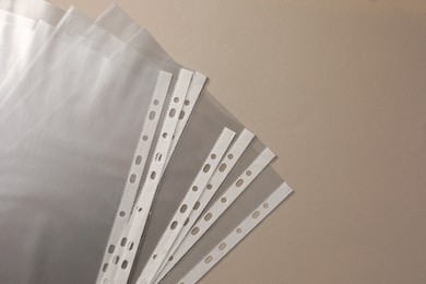 Photo of Punched pockets on light grey background, flat lay. Space for text
