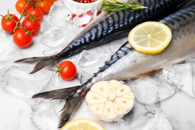 Photo of Tasty raw mackerel and ingredients on white marble table, closeup