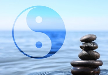 Stack of stones in water and Ying Yang symbol. Feng Shui philosophy 