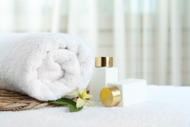 Composition with cosmetic products on white towel indoors, space for text. Spa therapy