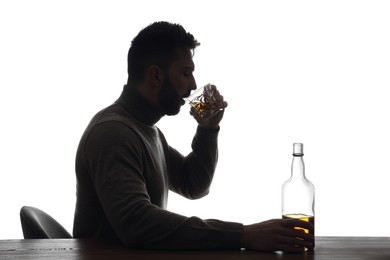 Silhouette of addicted man drinking alcohol on white background