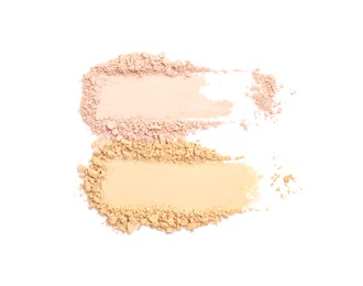 Swatches of different crushed face powders on white background, top view