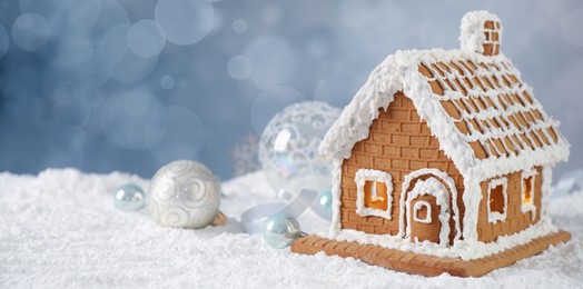 Beautiful gingerbread house decorated with icing on snow, space for text. Banner design