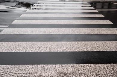 Photo of Pedestrian crossing in city outdoors after rain