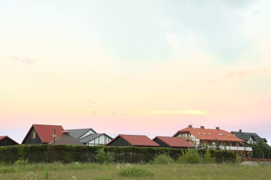 Photo of Modern buildings with different roofs outdoors on spring day