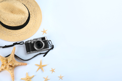 Camera for professional photographer and beach objects on white background, top view