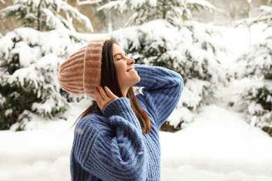 Pretty woman in warm sweater outdoors on winter day