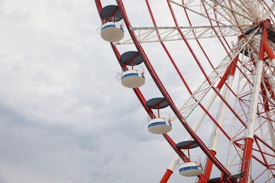 Beautiful large Ferris wheel outdoors, low angle view. Space for text