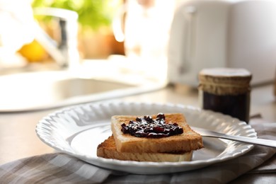 Tasty toasts with jam on countertop in kitchen, closeup