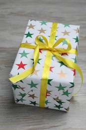 Photo of Beautifully wrapped gift box on wooden table, closeup