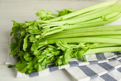 Photo of Fresh ripe green celery on white wooden table