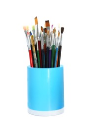 Set of paintbrushes in holder on white background