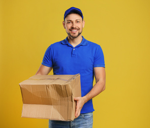 Courier with damaged cardboard box on yellow background. Poor quality delivery service