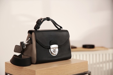 Elegant black bag on table in luxury boutique