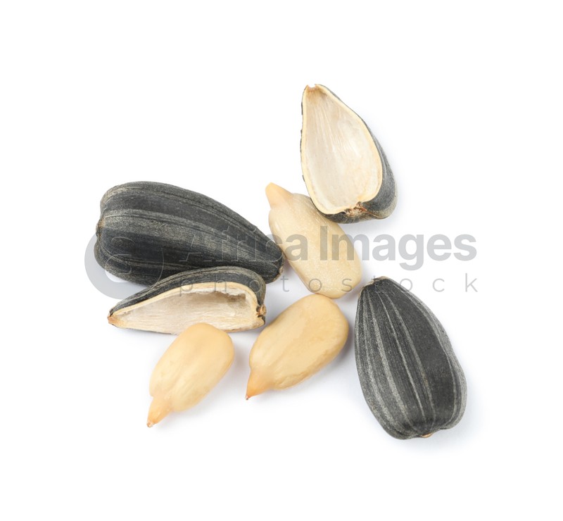 Photo of Raw peeled sunflower seeds and shell isolated on white, top view