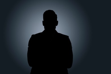 Silhouette of anonymous man on dark background
