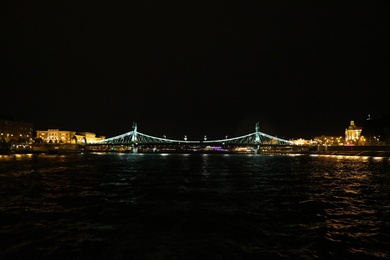 BUDAPEST, HUNGARY - APRIL 27, 2019: Beautiful night cityscape with illuminated Liberty Bridge across Danube river