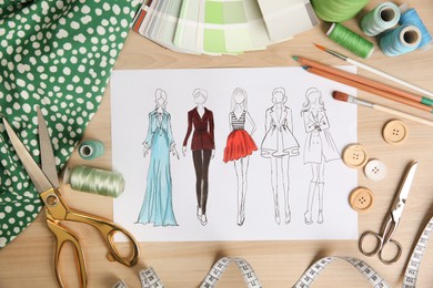 Sketch of fashion clothes and thread supplies at designer's workplace, flat lay