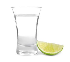 Mexican Tequila shot with lime slice isolated on white