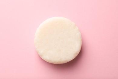 Solid shampoo bar on pink background, top view