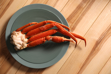 Photo of Piece of fresh raw crab on wooden table, top view