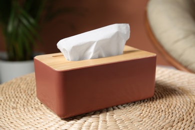Box with paper tissues on table in room, closeup
