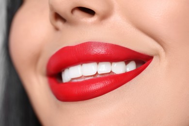 Young woman wearing beautiful red lipstick, closeup