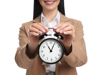 Businesswoman holding alarm clock on white background, closeup. Time management