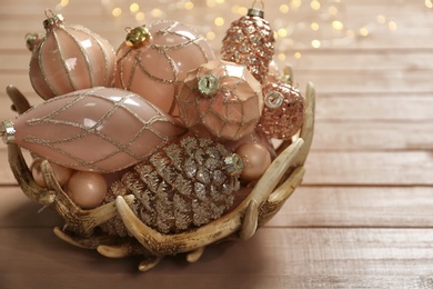 Collection of beautiful Christmas tree baubles on wooden table, closeup