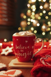 Tasty hot drink in cup with inscription Believe in Magic. Christmas atmosphere