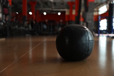 Medicine ball on floor in gym. Space for text
