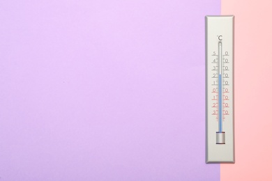 Weather thermometer on color background, top view. Space for text