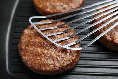 Tasty fried hamburger patties on grill pan, closeup