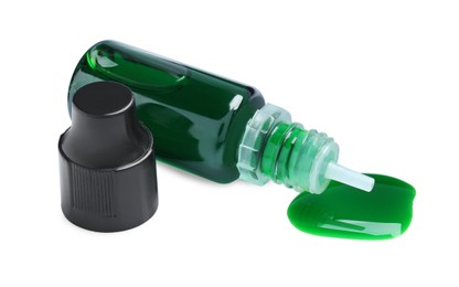 Photo of Bottle of green food coloring on white background