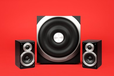 Modern powerful audio speaker system on red background