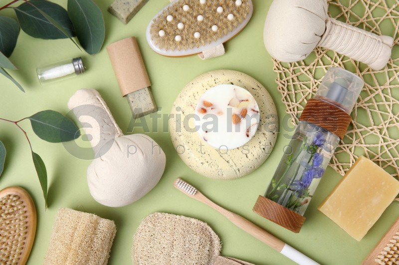 Eco friendly personal care products on light green background, flat lay