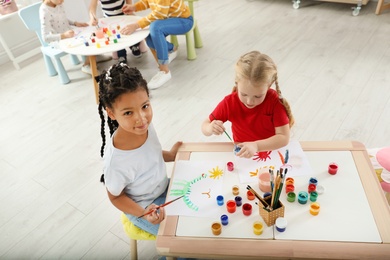 Cute little children painting at lesson indoors