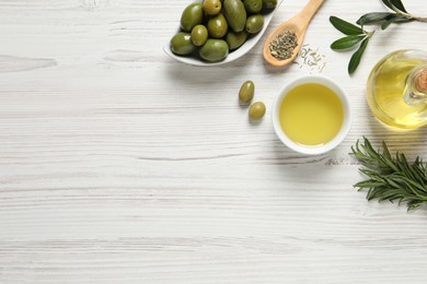 Flat lay composition with olive oil on white wooden table, flat lay. Space for text